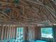 Interior view of a new construction build with exposed wood framing and construction materials at 1 Fisher Lane Way, Ocklawaha, FL 32179