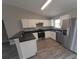 An open kitchen has stainless appliances, grey counters and white cabinets at 1 Fisher Lane Way, Ocklawaha, FL 32179