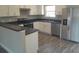 Bright kitchen features stainless steel appliances, gray countertops, and ample white cabinetry at 1 Fisher Lane Way, Ocklawaha, FL 32179