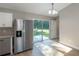 Contemporary kitchen area with stainless steel appliances and sliding glass doors to the back yard at 1 Fisher Lane Way, Ocklawaha, FL 32179