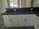 Close up of a kitchen featuring gray countertops, white cabinets, and stainless hardware at 1 Fisher Lane Way, Ocklawaha, FL 32179