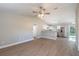 Open-concept living room with hardwood floors leading into the modern kitchen area at 1 Fisher Lane Way, Ocklawaha, FL 32179