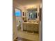 Hall bathroom featuring large mirror and vanity at 10824 Sw 90Th Ter, Ocala, FL 34481