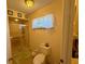 Bathroom with standing shower, toilet, and window at 10824 Sw 90Th Ter, Ocala, FL 34481