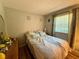 Bedroom featuring a bed, dresser, window, and hardwood style floors at 10824 Sw 90Th Ter, Ocala, FL 34481