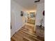 Hallway with decorative dresser leads to the bathroom with a double sink vanity and tile flooring at 10824 Sw 90Th Ter, Ocala, FL 34481