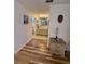 Hallway with decorative dresser leads to the bathroom with a double sink vanity and tile flooring at 10824 Sw 90Th Ter, Ocala, FL 34481