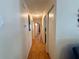 Hallway featuring wood floors and white walls with access to multiple rooms at 10824 Sw 90Th Ter, Ocala, FL 34481