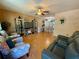 Living room with hardwood floors, comfortable seating, and display cabinets at 10824 Sw 90Th Ter, Ocala, FL 34481