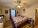 Bedroom featuring a ceiling fan, window, closet, and hardwood floors at 10824 Sw 90Th Ter, Ocala, FL 34481