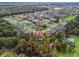 An aerial view of a large, landscaped property with a screened in pool at 11084 Se 168Th Loop, Summerfield, FL 34491