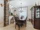 Traditional dining room features a stone pillar, chandelier lighting, and elegant decor at 11084 Se 168Th Loop, Summerfield, FL 34491