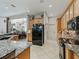 Spacious kitchen featuring wood cabinetry, granite countertops, and black appliances at 11084 Se 168Th Loop, Summerfield, FL 34491