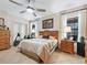 Serene main bedroom featuring natural light, ceiling fan, and wood furnishings at 11084 Se 168Th Loop, Summerfield, FL 34491