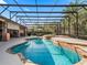 A dazzling pool with stone accents, an integrated spa, and a screened enclosure offering privacy and enjoyment at 11084 Se 168Th Loop, Summerfield, FL 34491