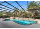 Enclosed pool with brick coping, a tranquil fountain, and surrounding palm trees under a screened enclosure at 11084 Se 168Th Loop, Summerfield, FL 34491