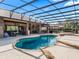 Screened-in pool showcasing stone detailing, spa, outdoor seating, and inviting lounge areas for relaxation at 11084 Se 168Th Loop, Summerfield, FL 34491