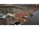 Aerial view of waterfront properties, showcasing boat houses and docks along a tranquil river at 11619 Lane Park Rd, Tavares, FL 32778