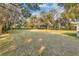 A sprawling lawn with mature trees provides a serene backdrop for this inviting property at 11619 Lane Park Rd, Tavares, FL 32778