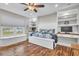 Bedroom featuring built-in desks, a bay window, and wood floors at 11619 Lane Park Rd, Tavares, FL 32778