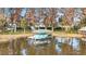 A boat sits serenely in it's boat house next to the water at 11619 Lane Park Rd, Tavares, FL 32778