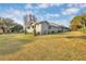 A sprawling lawn frames this charming home, complete with mature trees and manicured landscaping at 11619 Lane Park Rd, Tavares, FL 32778