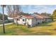 A beautifully landscaped yard surrounds this attractive home with a new-looking roof at 11619 Lane Park Rd, Tavares, FL 32778