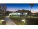 Inviting home exterior at twilight featuring manicured landscaping and a winding driveway at 11619 Lane Park Rd, Tavares, FL 32778