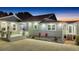 Exterior view of a well-maintained home featuring a garden bed, covered porch, and concrete driveway at 11619 Lane Park Rd, Tavares, FL 32778