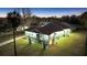 Well-lit home exterior featuring manicured lawn, bay window, and attached sunroom at 11619 Lane Park Rd, Tavares, FL 32778