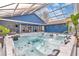 Enclosed hot tub area with seating, dining, and easy access to the pool and indoor entertainment spaces at 11619 Lane Park Rd, Tavares, FL 32778