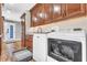 A stylish laundry room features modern appliances, granite countertops, and ample cabinet space at 11619 Lane Park Rd, Tavares, FL 32778