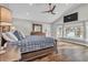 Serene main bedroom with a hardwood floor, vaulted ceilings, and a bay window overlooking the lake at 11619 Lane Park Rd, Tavares, FL 32778