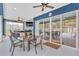 Outdoor patio area with a dining table and a view of the indoor pool through large glass doors at 11619 Lane Park Rd, Tavares, FL 32778