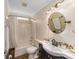 Bathroom featuring modern sink, vanity, shower and decorative mirror, with neutral tones at 11725 79Th Cir, Ocala, FL 34476