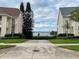 Scenic view of the lake between two townhomes with manicured lawns and a stone walkway at 130 Harbour Cove Way, Clermont, FL 34711