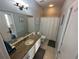 Functional bathroom featuring a vanity with granite countertop and a shower with curtain at 130 Harbour Cove Way, Clermont, FL 34711