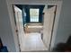 Inviting bathroom showcases a large soaking tub and tiled flooring, viewed through an open doorway at 130 Harbour Cove Way, Clermont, FL 34711