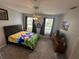 Bedroom featuring a ceiling fan, plush carpeting, and bright windows at 130 Harbour Cove Way, Clermont, FL 34711