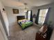 Comfortable bedroom featuring a ceiling fan, plush carpeting, and bright windows at 130 Harbour Cove Way, Clermont, FL 34711