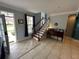 Welcoming entryway featuring tile floors, an elegant staircase, and natural light at 130 Harbour Cove Way, Clermont, FL 34711