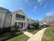 Charming townhome with a covered porch, manicured lawn, and inviting curb appeal at 130 Harbour Cove Way, Clermont, FL 34711