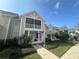 Beautiful two-story home with a screened balcony, lovely landscaping, and an inviting front entrance at 130 Harbour Cove Way, Clermont, FL 34711