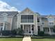 Charming two-story home with a welcoming front porch, manicured landscaping, and a classic American flag at 130 Harbour Cove Way, Clermont, FL 34711