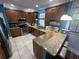 Bright kitchen featuring wood cabinets, granite countertops, stainless steel appliances, and bar top seating at 130 Harbour Cove Way, Clermont, FL 34711