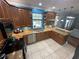 Stylish kitchen with wood cabinets, granite countertops, stainless steel appliances, and tile flooring at 130 Harbour Cove Way, Clermont, FL 34711