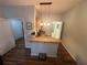 Well-lit kitchenette featuring a breakfast bar, hanging pendant lights, and wood-look flooring at 130 Harbour Cove Way, Clermont, FL 34711