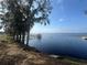 Stunning lake view featuring a pier, clear water, and distant shoreline, offering a peaceful vista at 130 Harbour Cove Way, Clermont, FL 34711