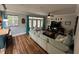 Bright living room with hardwood floors, ceiling fan, french doors, and a comfortable sofa at 130 Harbour Cove Way, Clermont, FL 34711