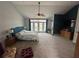 Large bedroom featuring a vaulted ceiling, ceiling fan, French doors, and en-suite bathroom at 130 Harbour Cove Way, Clermont, FL 34711